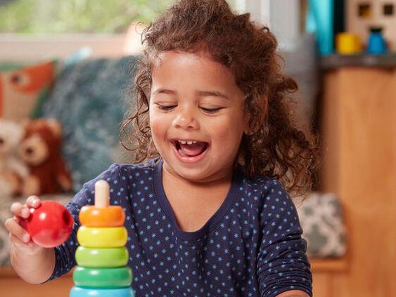 2-year-old girl playing with montessori toy
