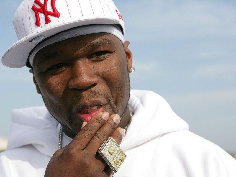 50 Cent rubbing his face with ring