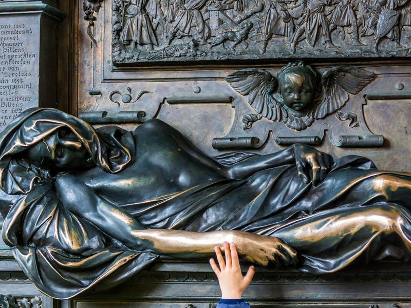 A kid's hand touching the statue of Everard  t' Serclaes in Brussels, Belgium