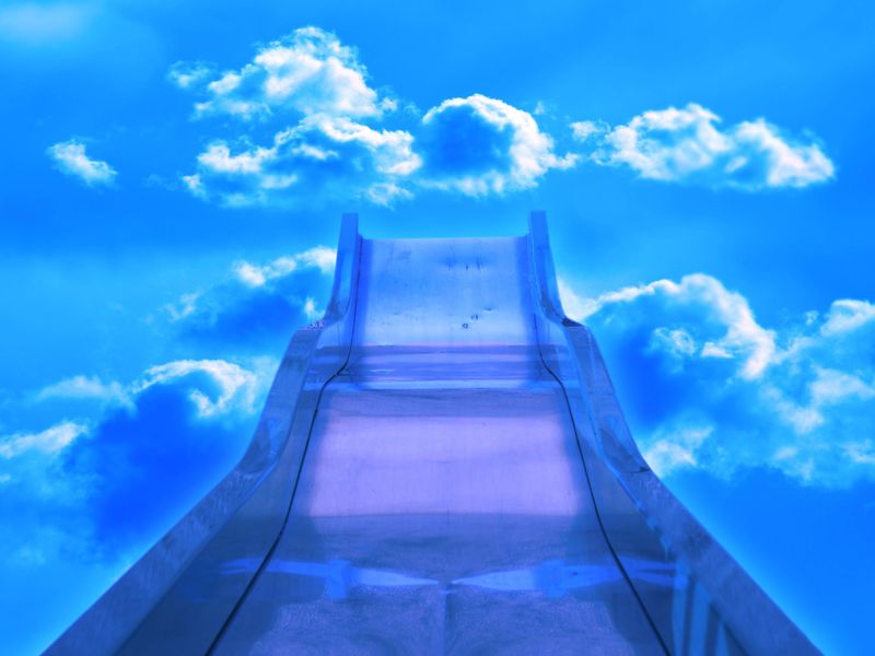 A slide in the blue sky heading toward the clouds