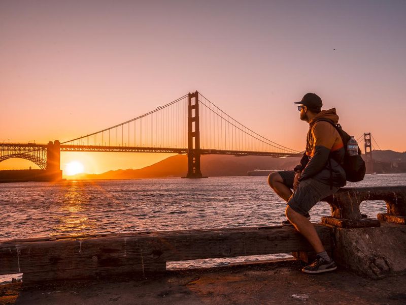 A young man in the red sunset at the Golden Gate in San Francisco. USA