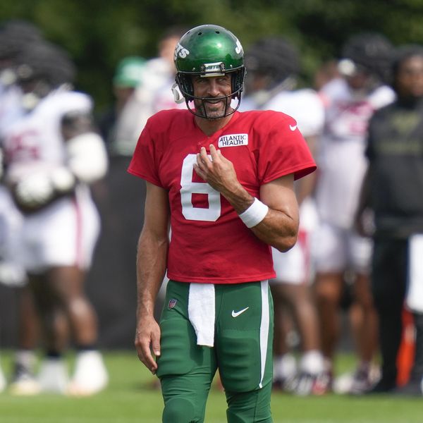New York Jets quarterback Aaron Rodgers smiles during a joint NFL football practice with the Tampa Bay Buccaneers, Wednesday, Aug. 16, 2023, in Florham Park, N.J. (AP Photo/Seth Wenig)