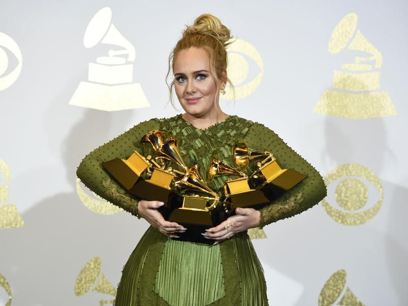 Adele posing with her Grammys