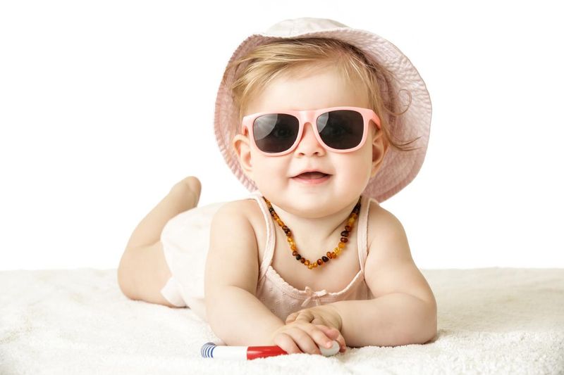 Adorable baby girl wearing pink plastic sunglasses