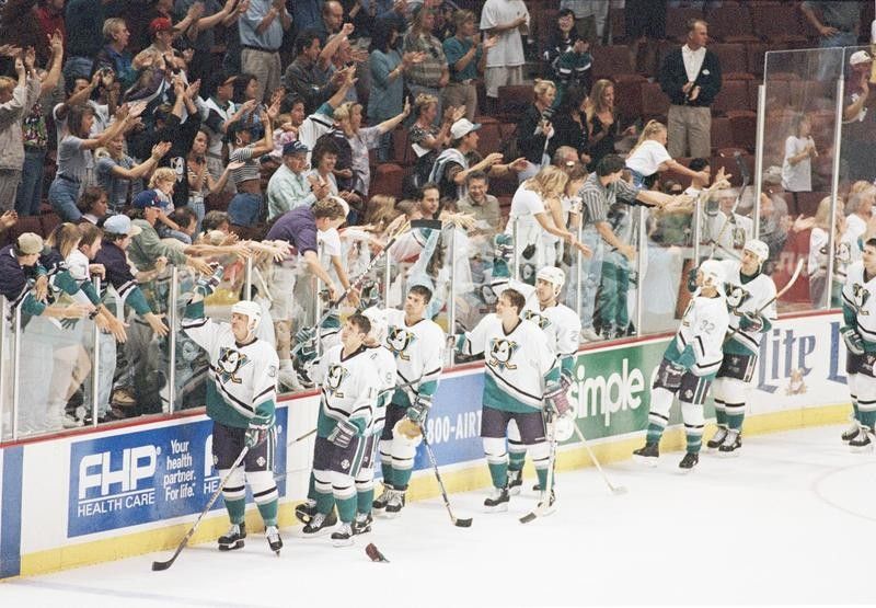 Anaheim Mighty Ducks players give high fives to fans