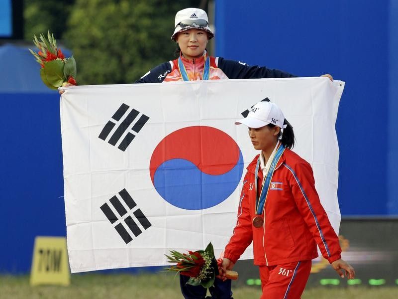 Athlete holding South Korean flag at Asian Games in 2010