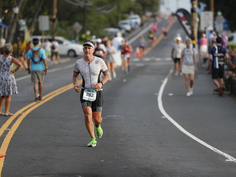 Athletes run down Ali'i Drive during Ironman Triathlon