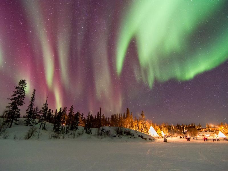 Aurora Borealis over tepees in Yellowknife