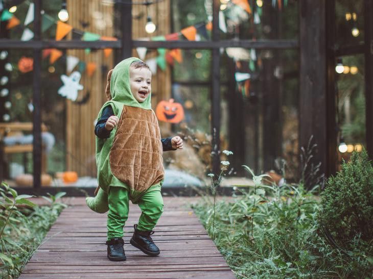 Baby boy in dinosaur costume