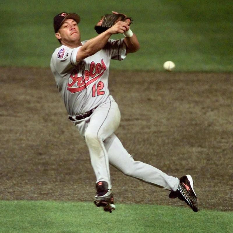 Baltimore Orioles' Roberto Alomar throws out Cleveland Indians' Bip Roberts