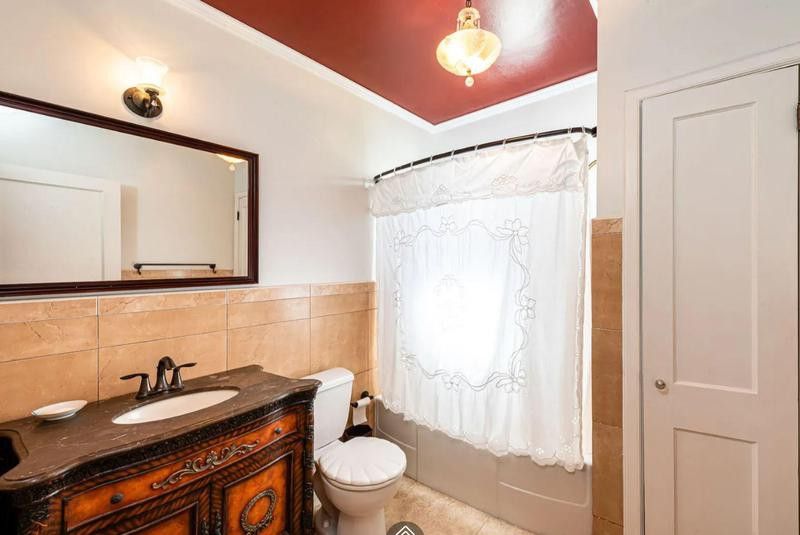Bathroom with small shower and red ceiling