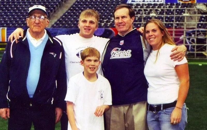 Bill Belichick of the New England Patriots poses with father Steve and family at the field