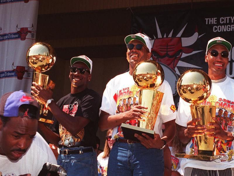 Bill Cartwright and Scottie Pippen show off team's NBA Championship trophies