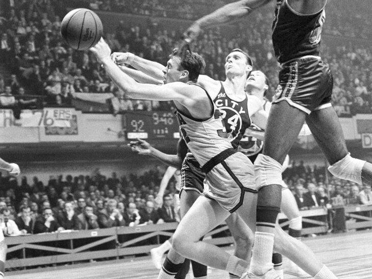 Billy Cunningham fights for a loose ball