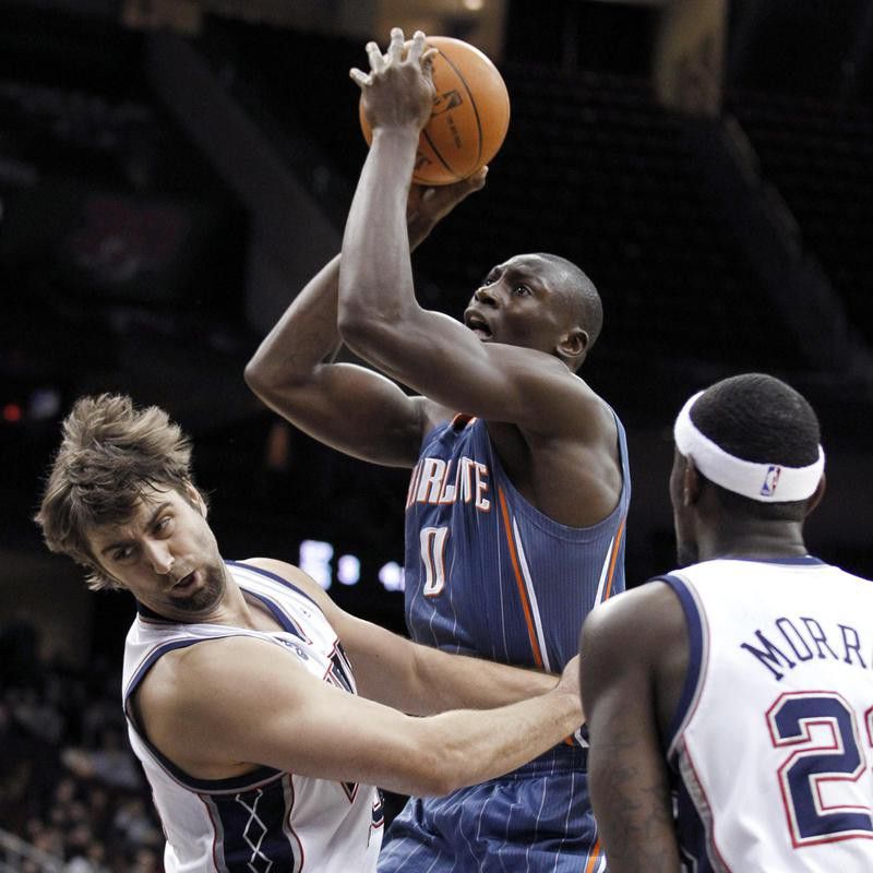Bismack Biyombo toes up for shot against New Jersey Nets' Mehmet Okur