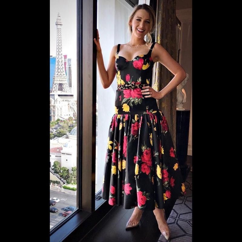 Blake Lively wearing a floral dress by the window