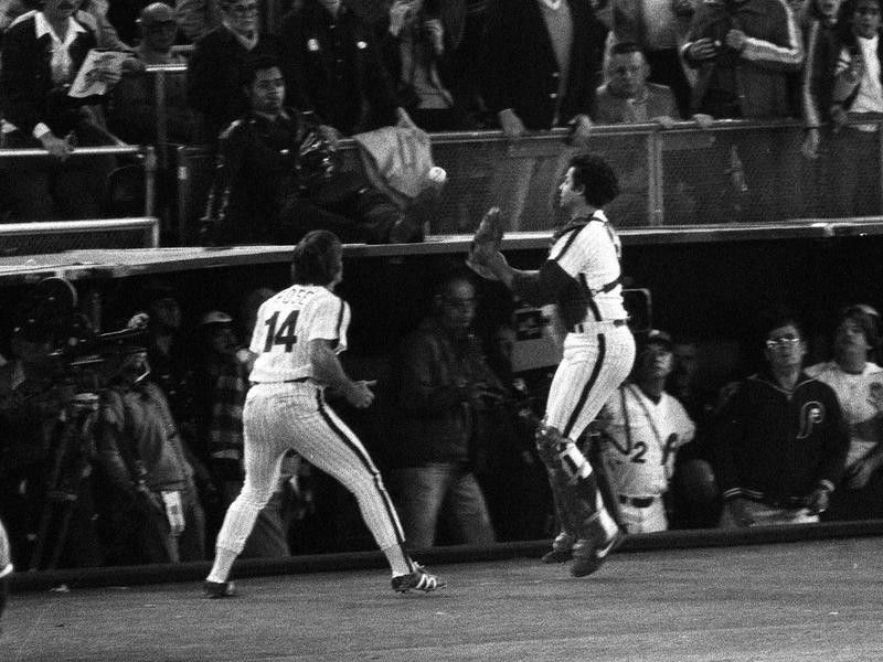 Bob Boone and teammate Pete Rose move to make foul pop fly catch in World Series