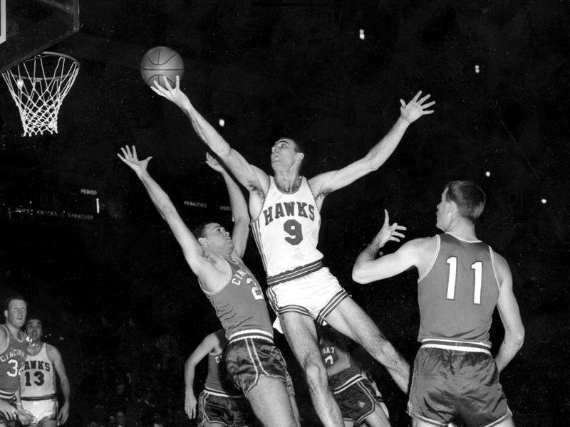 Bob Pettit leaps to make one handed shot