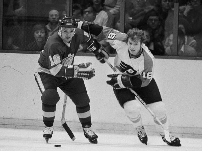 Bobby Clarke and Marcel Dionne battle for the puck