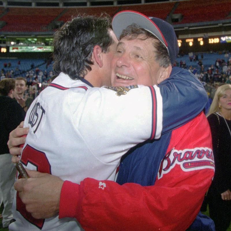Bobby Cox hugs bullpen coach Ned Yost