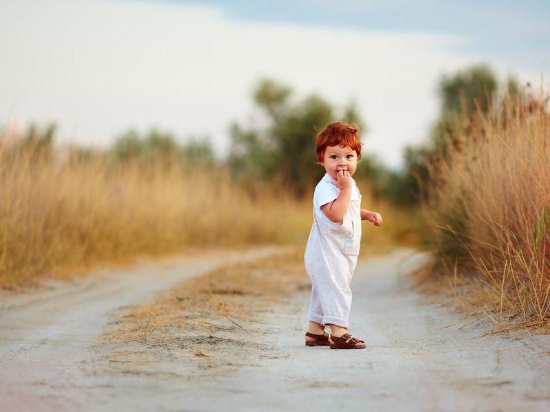 Bohemian baby boy walking with sandals