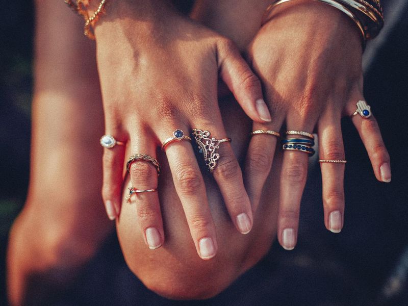 Boho girl's hands with many rings