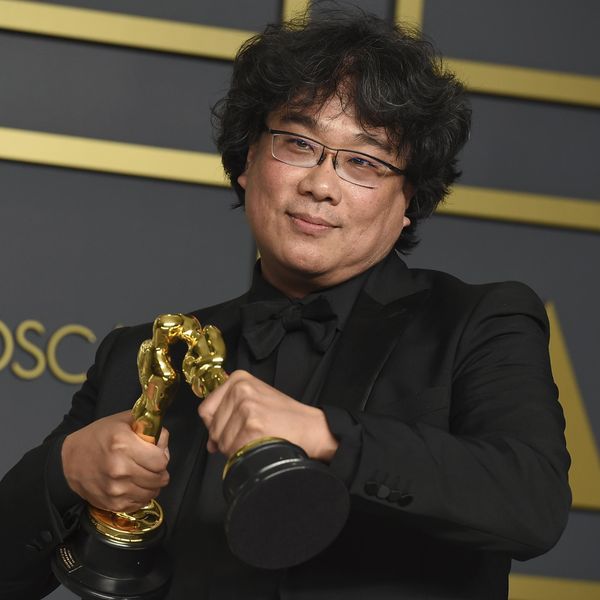 Bong Joon Ho poses in the press room with the awards for best director for "Parasite" and for best international feature film for "Parasite" from South Korea at the Oscars on Sunday, Feb. 9, 2020, at the Dolby Theatre in Los Angeles. (Photo by Jordan Strauss/Invision/AP)