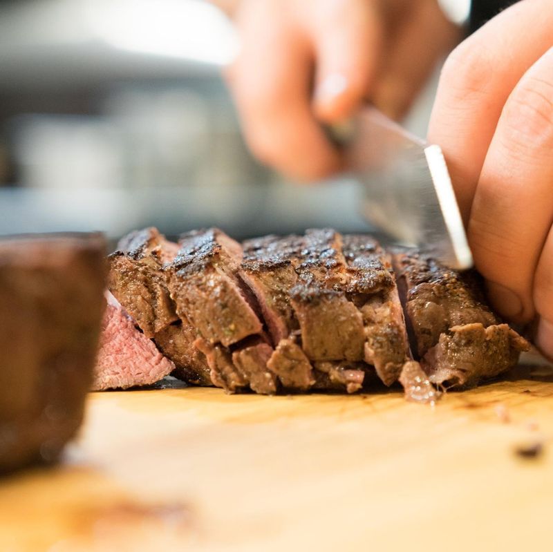 Bos Taurus chef cutting steak
