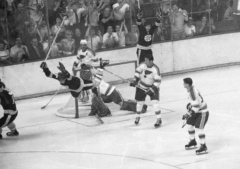 Boston Bruins' Bobby Orr flies through air after winning goal