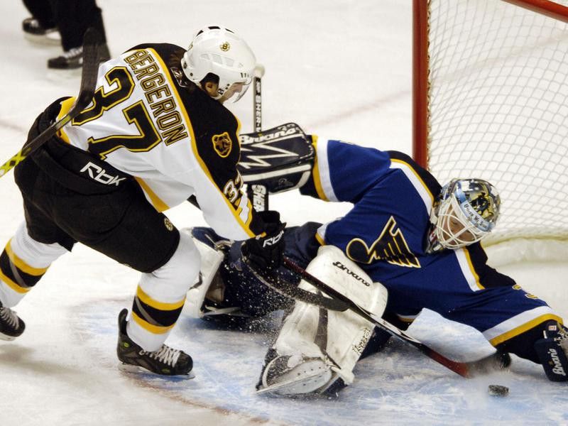 Boston Bruins' Patrice Bergeron scores against St. Louis Blues goaltender Manny Legace