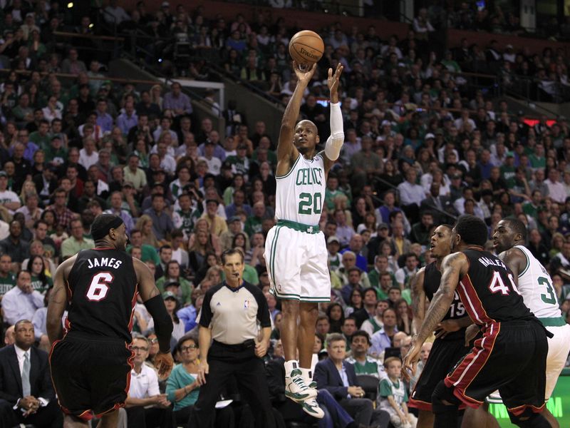 Boston Celtics guard Ray Allen shooting three-point shot between Miami Heat defenders