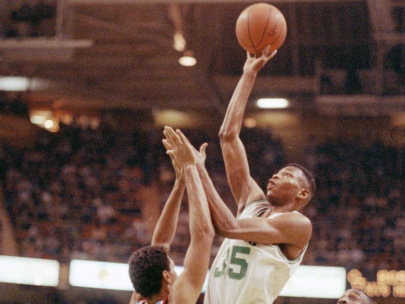 Boston Celtics guard Reggie Lewis goes up high with one-handed jump shot