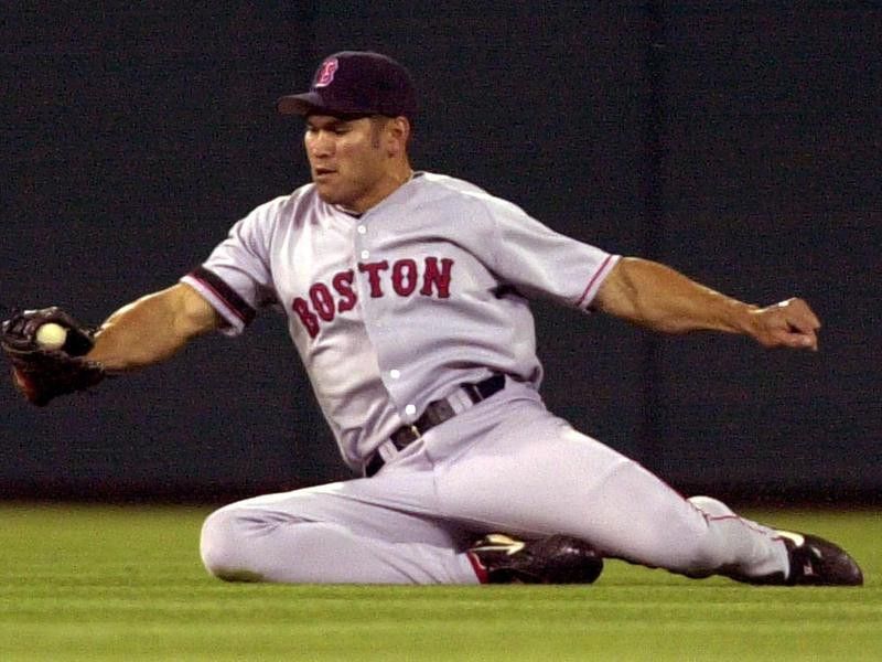Boston Red Sox's Johnny Damon slides to catch ball