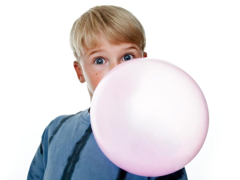 Boy blowing large bubble