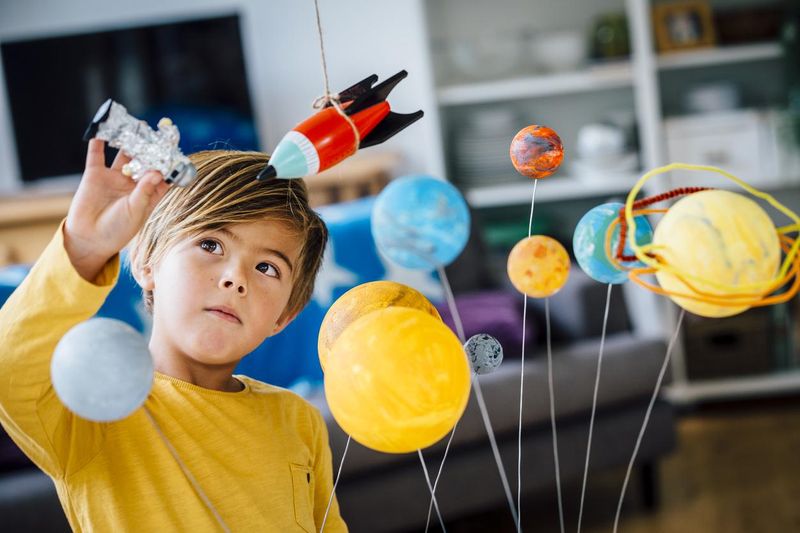 Boy playing with his astronaut toy