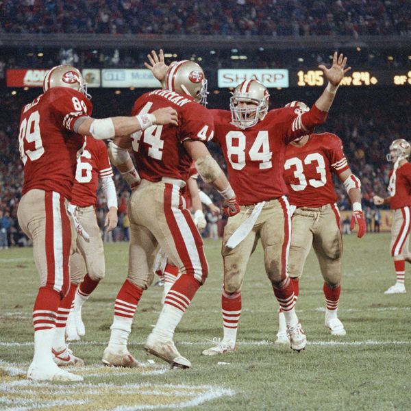 San Francisco 49ers tight end Brent Jones (84) goes to embrace fullback Tom Rathman (44) after Rathman scored a touchdown late in the fourth quarter against the New York Giants at Candlestick Park, San Francisco, Nov. 28, 1989. The 49ers defeated the Giants, 34-24.  (AP Photo/John Mabanglo)