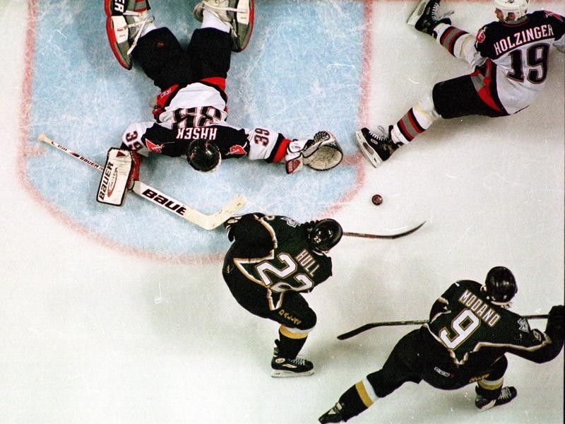 Brett Hull of the Dallas Stars shoots game winning goal against Buffalo Sabres in Stanley Cup Finals