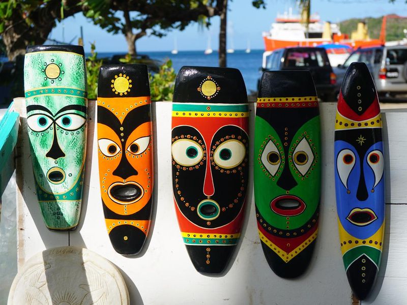 Brightly coloured hand-painted masks in Bequai, Grenada, Caribbean