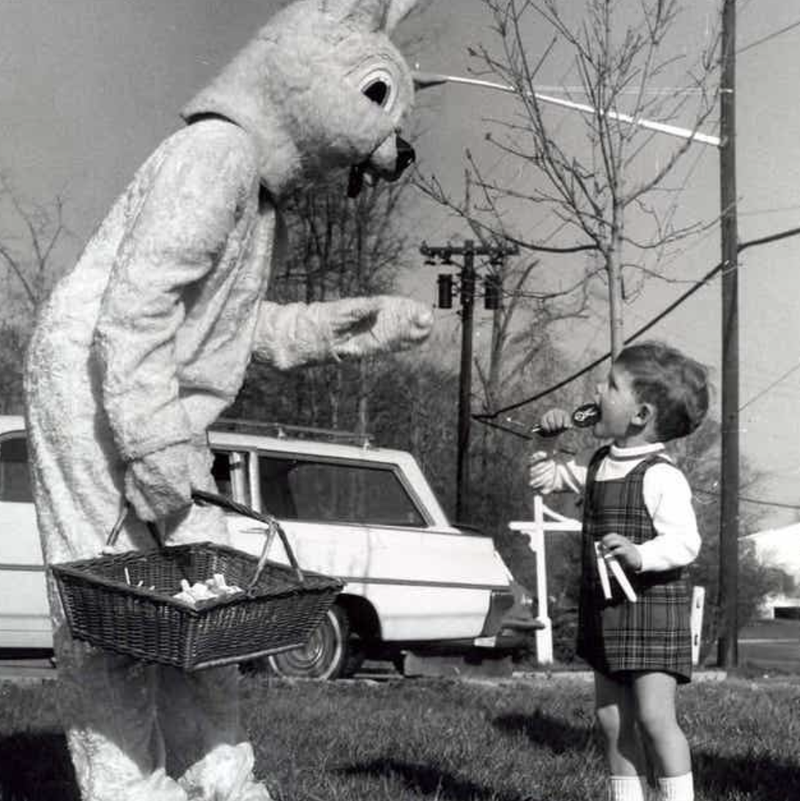 Bunny and child during Easter egg hunt