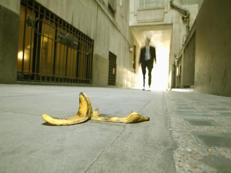 Businessman walking toward a banana peel
