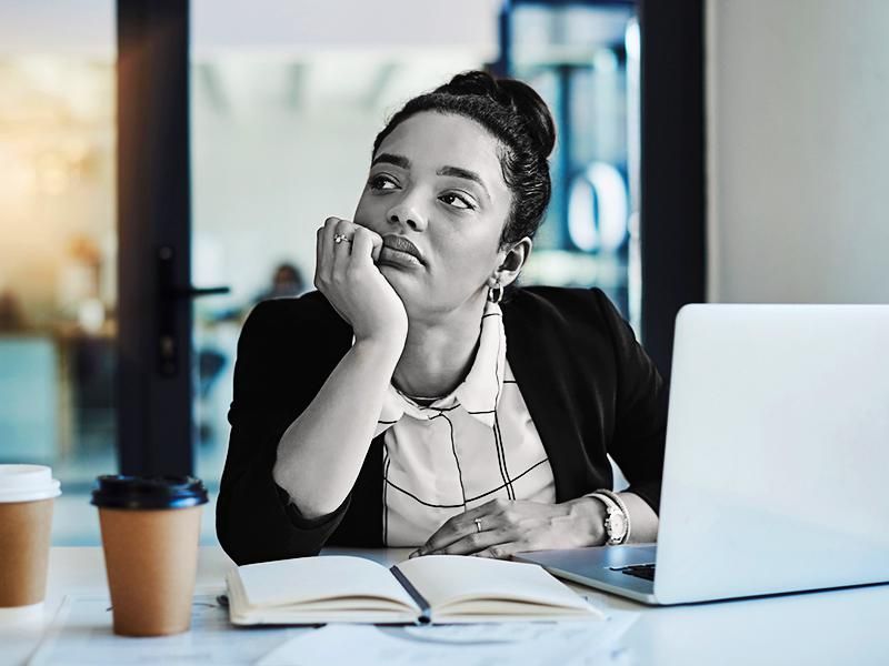 Businesswoman looking bored while working at her desk