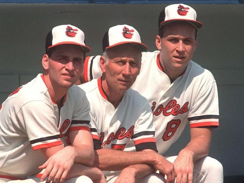 Cal Ripken Sr. kneeling with sons Billy and Cal Jr. at Baltimore Orioles training camp