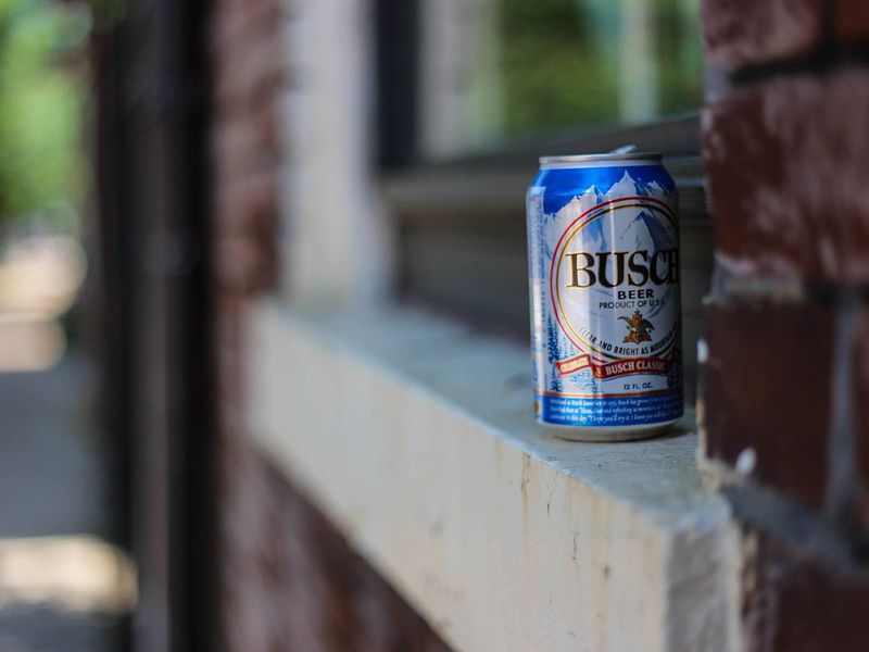 Can of Busch beer on window sill