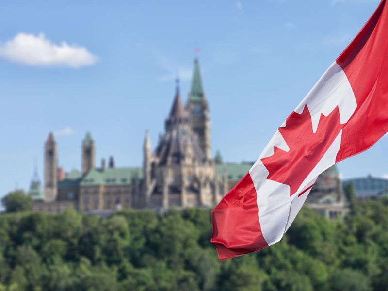 Canada flag with Parliament buildings in Ottawa