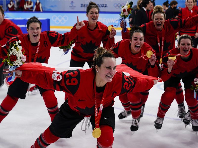 Canada's Marie-Philip Poulin celebrates with gold medal after women's gold medal hockey game