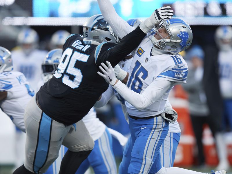 Carolina Panthers defensive tackle Derrick Brown hits Detroit Lions quarterback Jared Goff