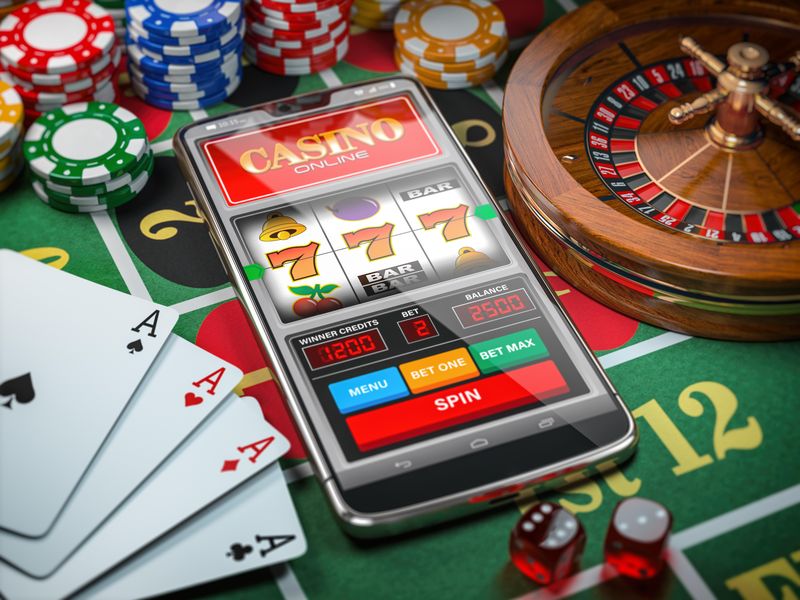 Casino online with slot machine game on smartphone, dice, cards and roulette wheel