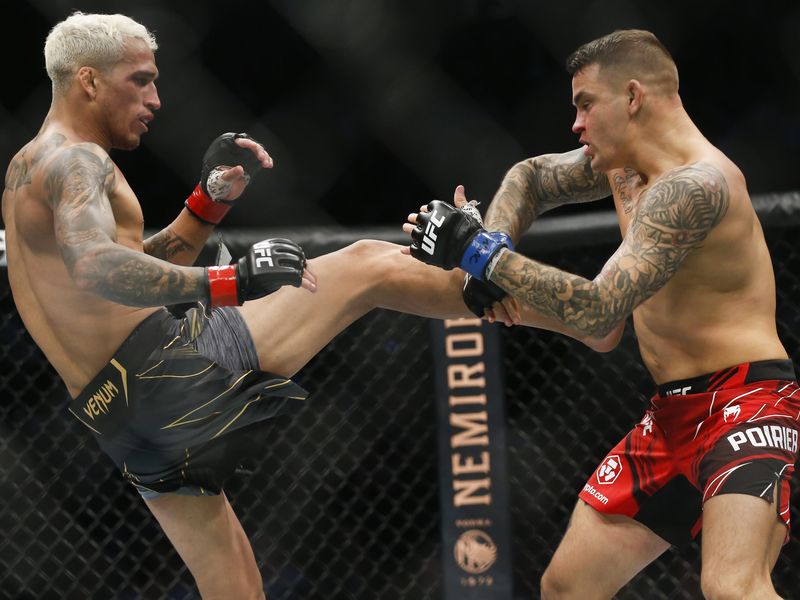 Charles Oliveira tries to kick Dustin Poirier during lightweight mixed martial arts title