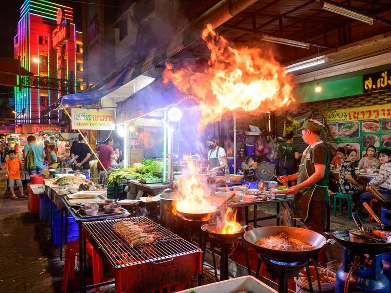 Chef cooking food at street side restaurant in Yaowarat road, Bangkok