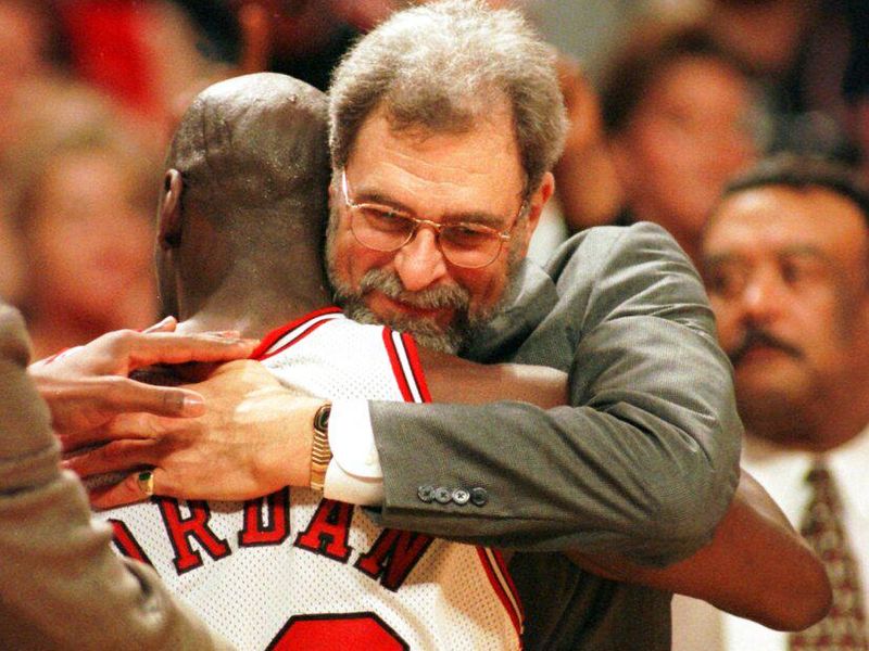 Chicago Bulls' coach Phil Jackson hugging Michael Jordan